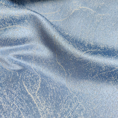 Light blue textured curtain fabric with metallic sheen and subtle abstract pattern