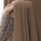 Close-up of hand holding deep walnut brown curtain fabric, textured home curtains