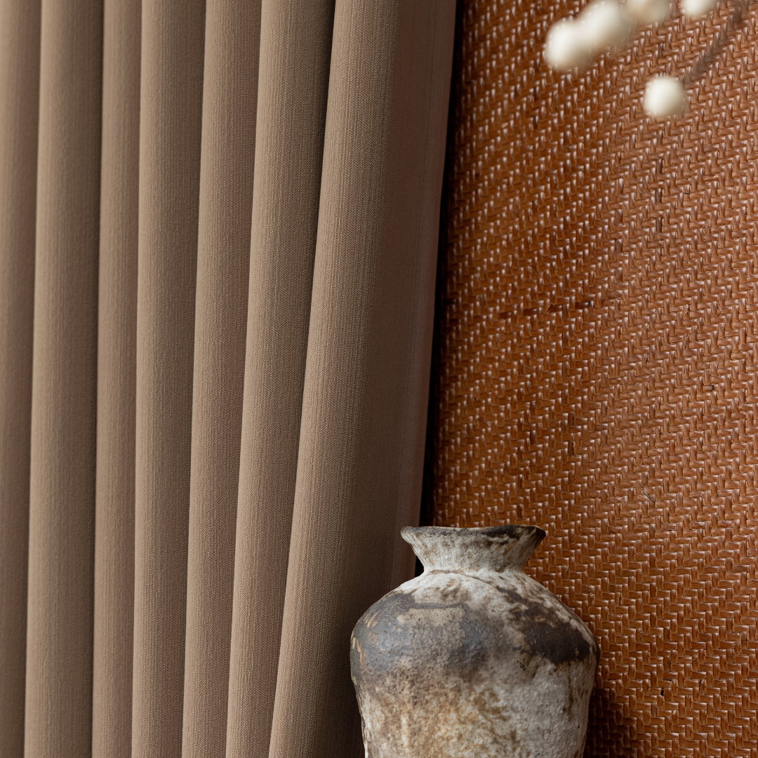 Deep walnut brown blackout curtain with textured vase and woven accent wall