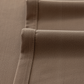 Close-up of deep walnut brown curtain fabric with textured weave and stitched edges