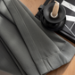 Graphite ash grey curtain fabric close-up on wooden table with book and candle