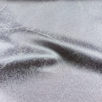 Grey silver textured curtain fabric sample with a subtle sheen