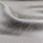 Close-up of silver greige textured curtain fabric with subtle sheen and soft folds