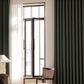 Modern living room with olive green blackout curtains and sheer white drapes on window