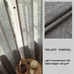 Charcoal grey textured curtains with natural light, light filtering, closeup fabric detail.